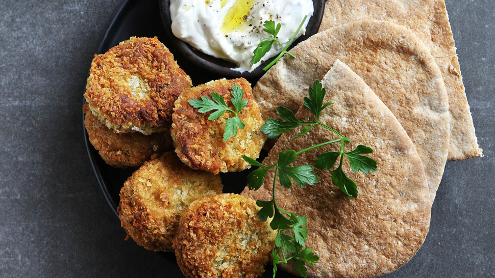 Falafel balls with yogurt dip and lettuce.Top view