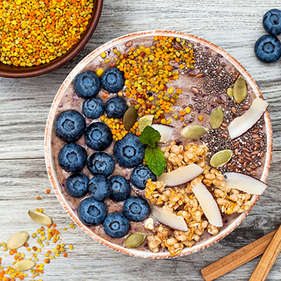 Acai breakfast superfoods smoothies bowl with chia seeds, bee pollen
