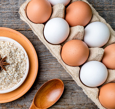 Ingredients for Breakfast Oatmeal Eggs Bread Apple Rustic Wooden background