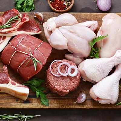 raw meat assortment – beef, lamb, chicken on a wooden board