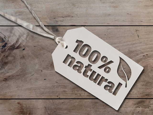 white hang tag cardboard lable with string attached an text 100 percent natural on rustic wooden table