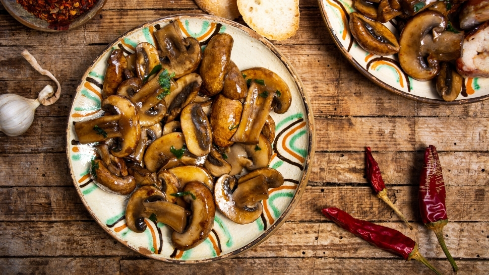 braised mushrooms and chiles on a white plate