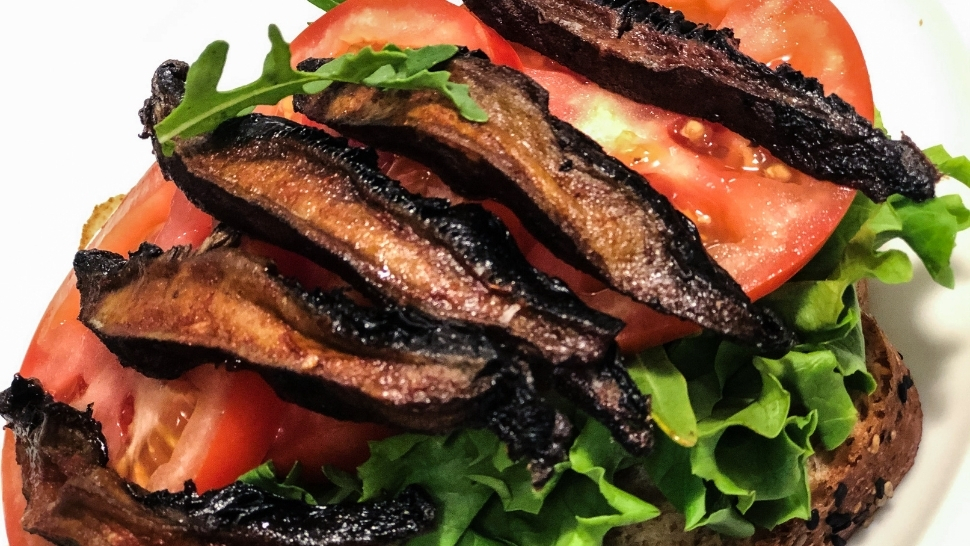 mushroom bacon, lettuce, and tomato sandwich on a white plate