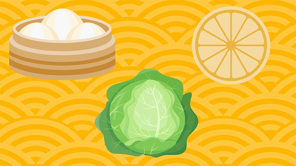 Steamed dumplings in a bamboo basket, napa cabbage, and a lemon slice on a festive gold Lunar New Year background