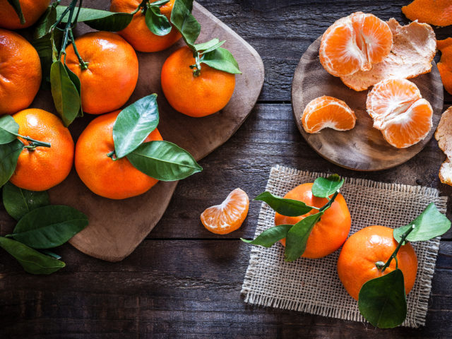 Fresh organic mandarins on rustic wooden table