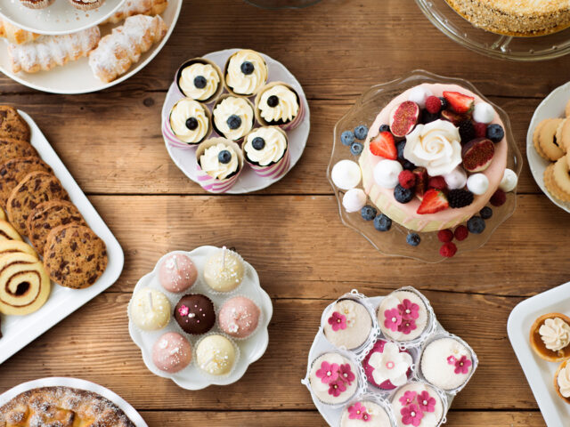 Table with cakes, cookies, cupcakes, tarts and cakepops.